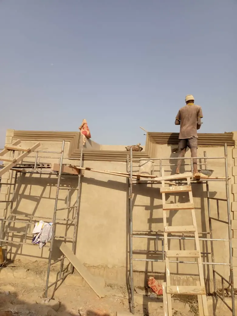 Workers on concrete and roofing structure