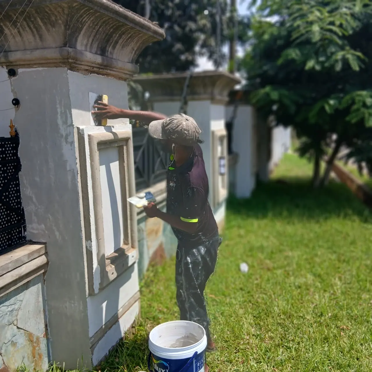 Worker painting an exterior wall