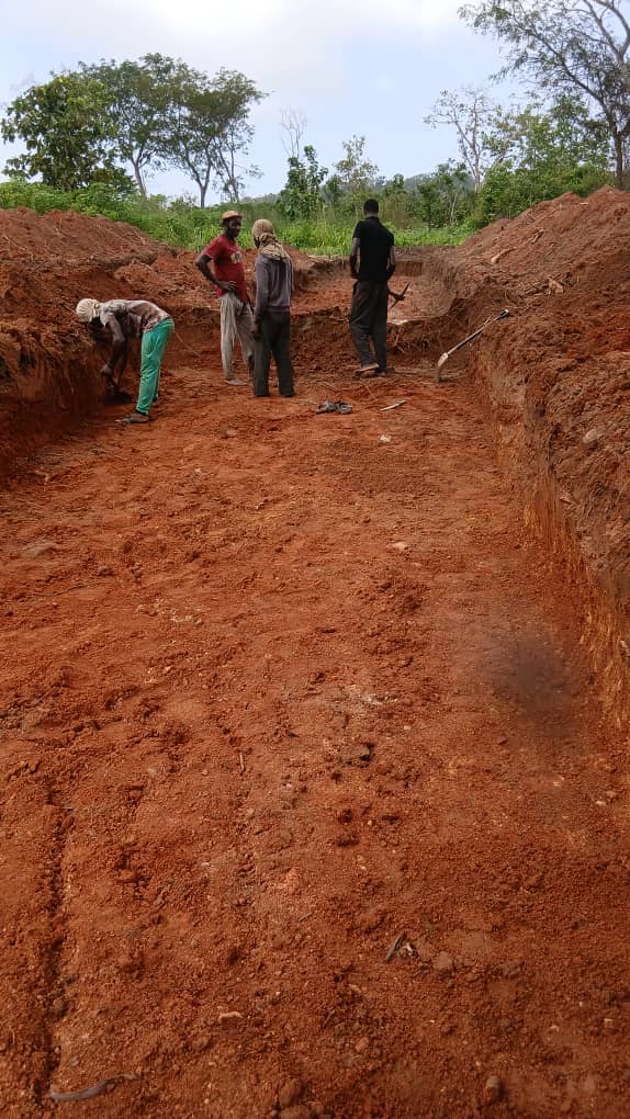 Workers preparing red earth site