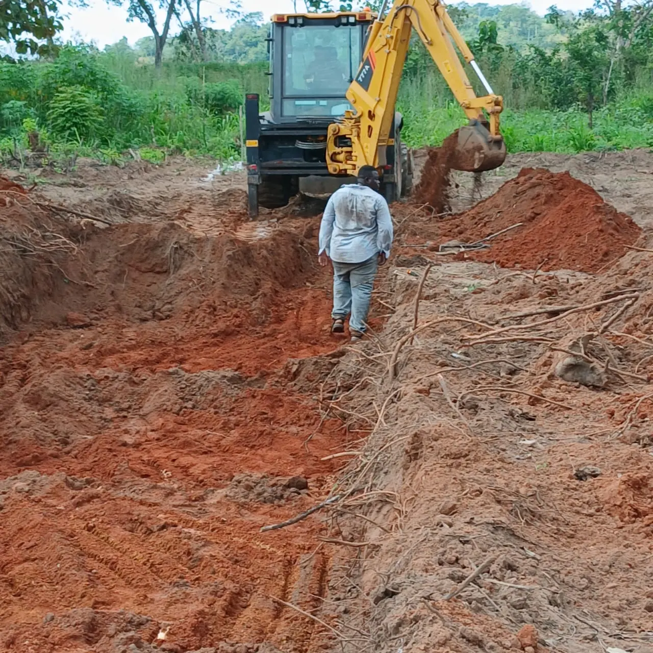 Excavator preparing construction area